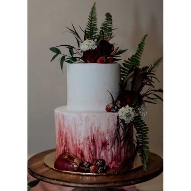 Wedding cake painted burgundy greenery flowers fruit best