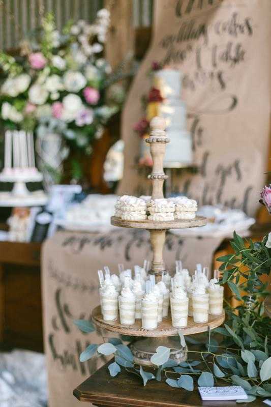 wedding dessert table vanilla cake shooters french macaroons vintage shabby chic barn